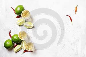 Golden tequila with lime on white drink background, top view