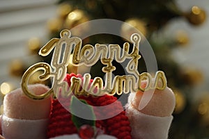 Golden text Mery Christmas in Santa Claus hands, New Year