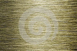 Golden texture of shiny scratched metal. Abstract gold background.