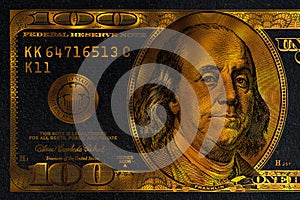 golden textured 100 US dollar banknote with black background