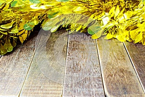 Golden Tinsel on wooden background