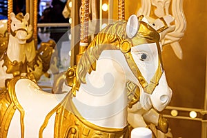 Golden toy horses from the carousel in the amusement park.