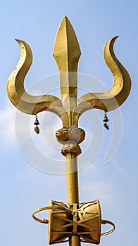 Golden trident or trishula.