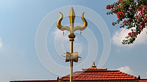 Golden trident or trishula.