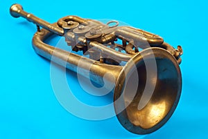 Golden trumpet on a blue background