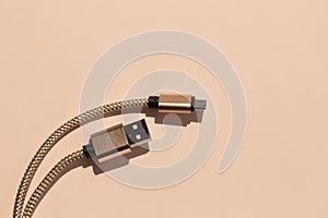 Golden USB cable and micro USB for smartphone, tablet or computer, stock image close-up