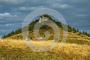 Golden valley against the background of a hill and cloudy sky. Big Fatra mountains, Slovakia.