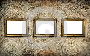 Golden vintage picture frame set with blank space on an old wall