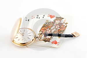 Golden watch and playing cards