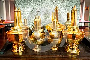Golden Water Container for pour water down the ground after the merit. To devote the merits to the dead