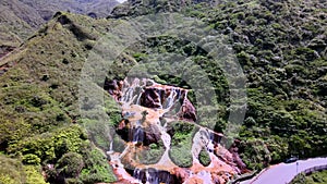 Golden Waterfall over rust-colored rocks & soil taiwan