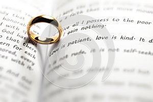 Golden wedding ring on bible book