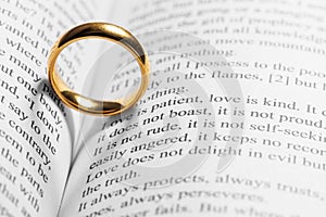 Golden wedding ring on bible book