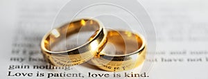 Golden wedding rings on bible book