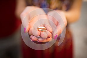 Golden wedding rings in hands of woman. Wedding details