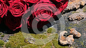 Golden wedding rings stylishly arranged in front of the bridal bouquet photo