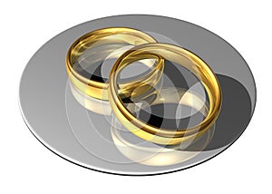 Golden wedding rings on a reflecting plate