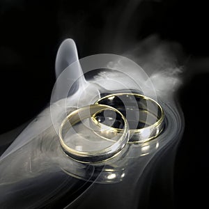 Golden wedding rings and smoke