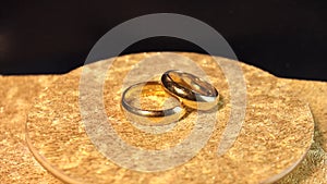 Golden wedding rings, wedding rings on a black background