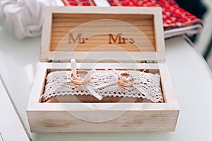 Golden wedding rings in a white wooden box. Wedding decoration. Symbol of family, unity and love
