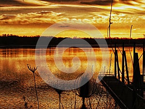 Golden whisps of clouds over the deep reddish gold river