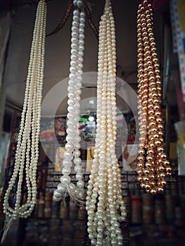 Golden and white beads or perls in a jewellery materials store