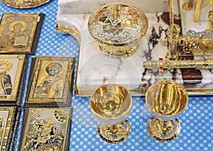 Golden wine glasses and writing materials on the table with icons