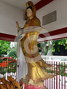 Golden woman sculpture near Wat tamachat, Thai temple. Bangkok.