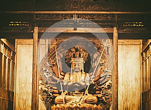 Golden Wood Statue of Guan Yin with thousand hands . Golden sculpture of Avalokiteshvara Buddha or Guanyin with thousand hands in