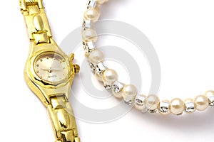 Golden wrist watch and necklace