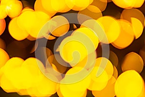 Golden yellow abstract background with bokeh defocused blurred lights.