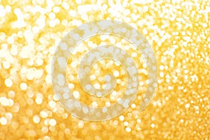 Golden yellow blurred glitter lights background