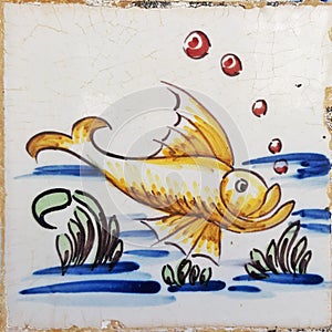 Golden yellow fish antique tile