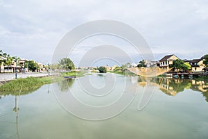 Golden yellow fishing net suspended over Thu Bon River in Hoi An, Vietnam