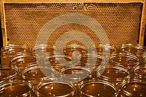 Golden yellow honey in glass jar on wooden board Closeup Copy space comp frame empty textspace