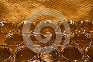 Golden yellow honey in glass jar on wooden board Closeup Copy space comp frame empty textspace