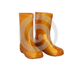 Golden-yellow rain boots on white background.