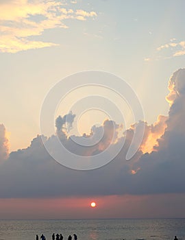 Golden Yellow Sun Setting over Ocean with Clouds in Bright Sky - Laxmanpur, Neil Island, Andaman, India