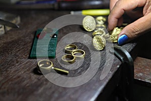 Goldsmith checking ring after casting.