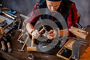Goldsmith making a ring for a client