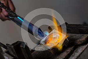 Goldsmith melting Silver Grains in crucible photo