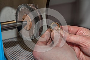 Goldsmith polishing a ring 2