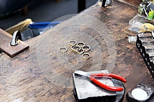 Goldsmith`s bench with some golden rings in process - selectived