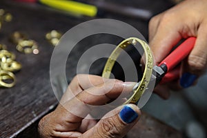 Goldsmith use Pliers cutting Bracelets.