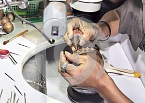 Goldsmith at work with traditional tools