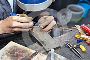 Goldsmith at work with traditional tools