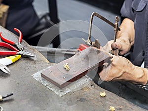Goldsmith at work with traditional tools