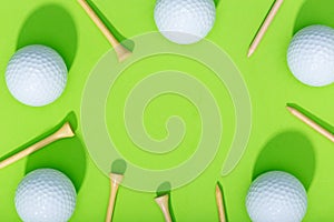 Golf background. Group of golf balls and tee on green background