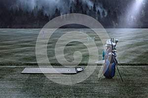 Golf bag on the driving range. Foggy nature. Background for the interior