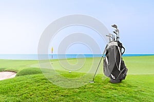 Golf bag and Golf Accessories Golf Set at golf course blue sea and blue sky as background